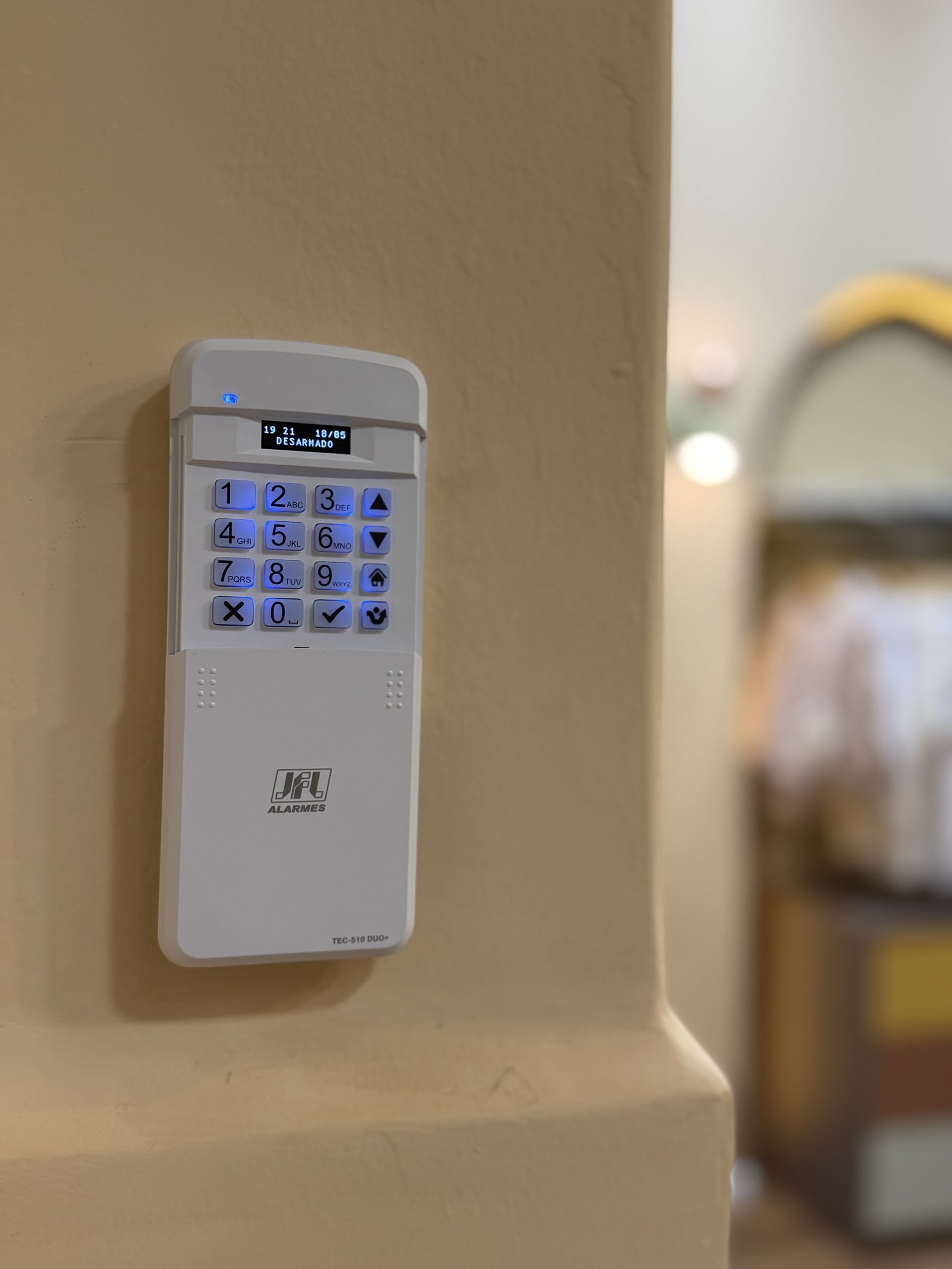 Painel de alarme JFL instalado em parede